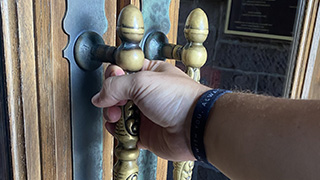 A photo of someone opening a door