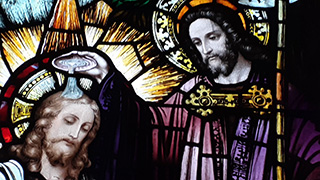 Stained glass window of the baptism in the seminary chapel 