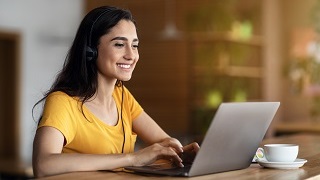 A girl typing on a laptop