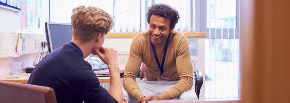 A student and an advisor in a meeting. 