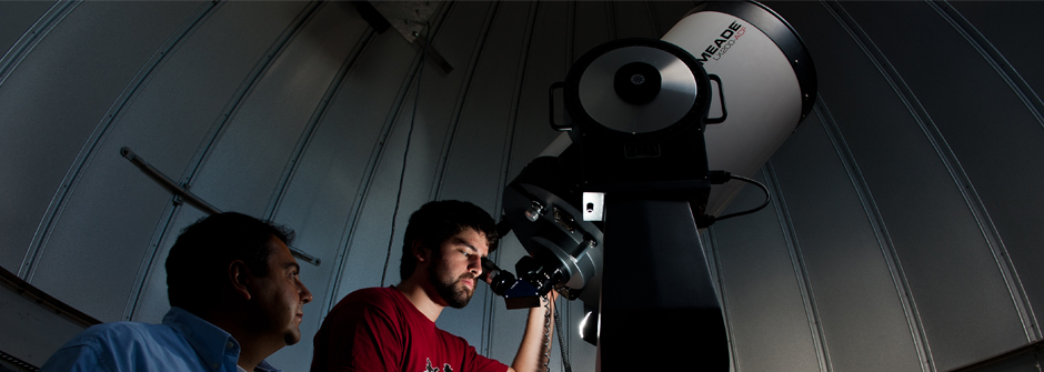 People looking though a telescope.