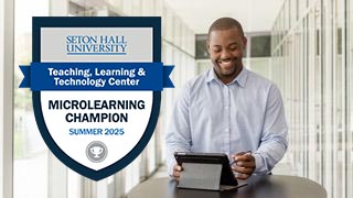 Badge alongside person at a laptop