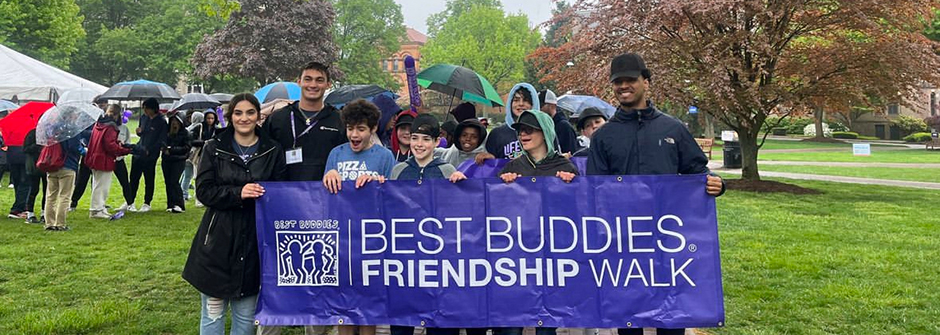 Image of the Best Buddies club doing a charity walk in the rain. 