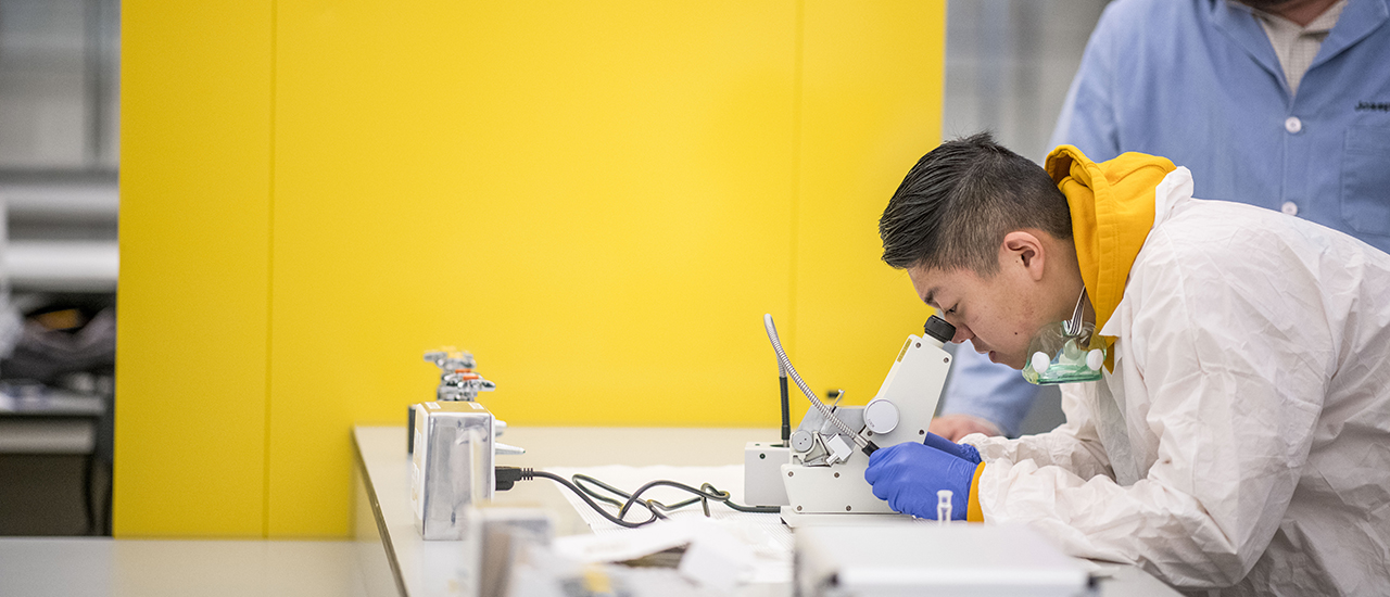 Image of a chemistry student working in a lab. 