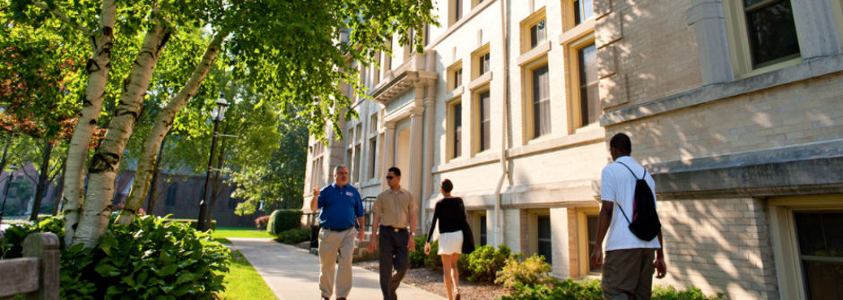 People walking on campus in front of Bayley Hall. 