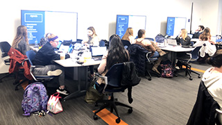 A photo of faculty learning about the DataLabA photo of students at the University LibraryA photo of students learning about the DataLab