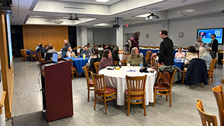 Faculty members conversing during lunch following Mass.