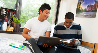 Two students sitting in a dorm 