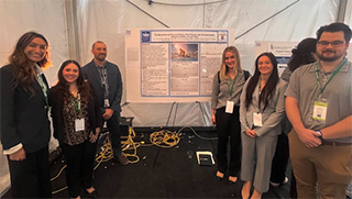 Group picture with presentation at conference