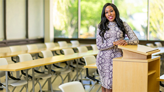 La'Tesha Sampson next to classroom podium