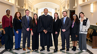 he Honorable Michael Shipp, pictured with law students after successful completion of their trial along with undergraduate student jurors.