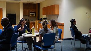 Faculty chatting with students