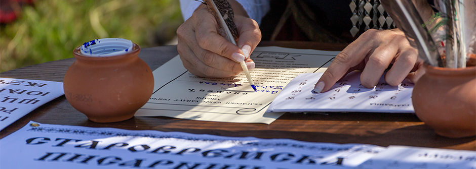 Signing a parchment piece of paper with feather By nikolay100.