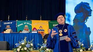 Msgr Reilly giving a speech