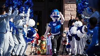 Pirate mascot running with children dressed up for halloween 