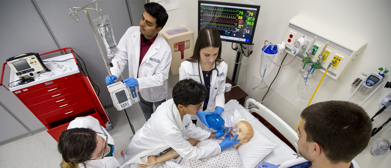 Health students working on a practice dummy 