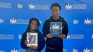 a junior and freshman holding SHU Blue spirit.