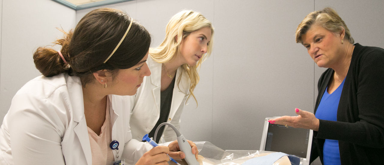 Nursing students learning from their professor