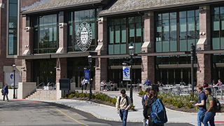 Students walking on campus in front of the University Center