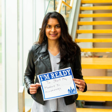 Zil Modi holding up a sign that reads 